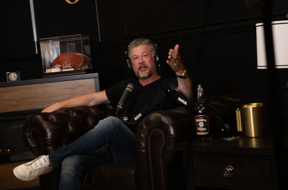 Elliot Omanson, founder of OWLFI, recording his market commentary show