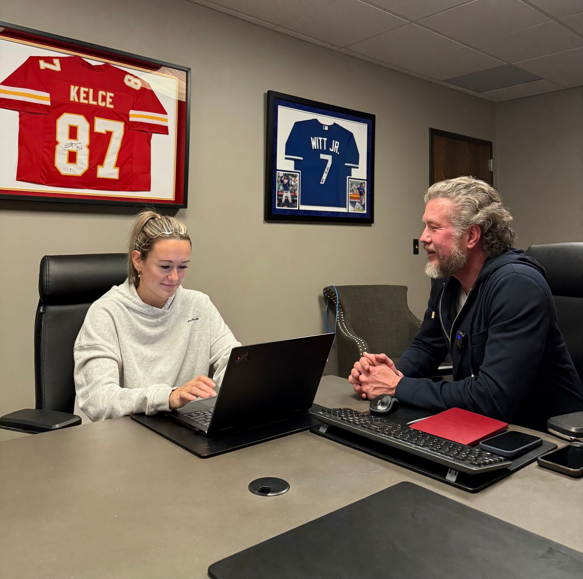 Elliot and Abby reviewing a plan at the office