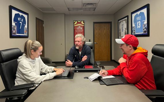 The OWLFI team working together around an office table